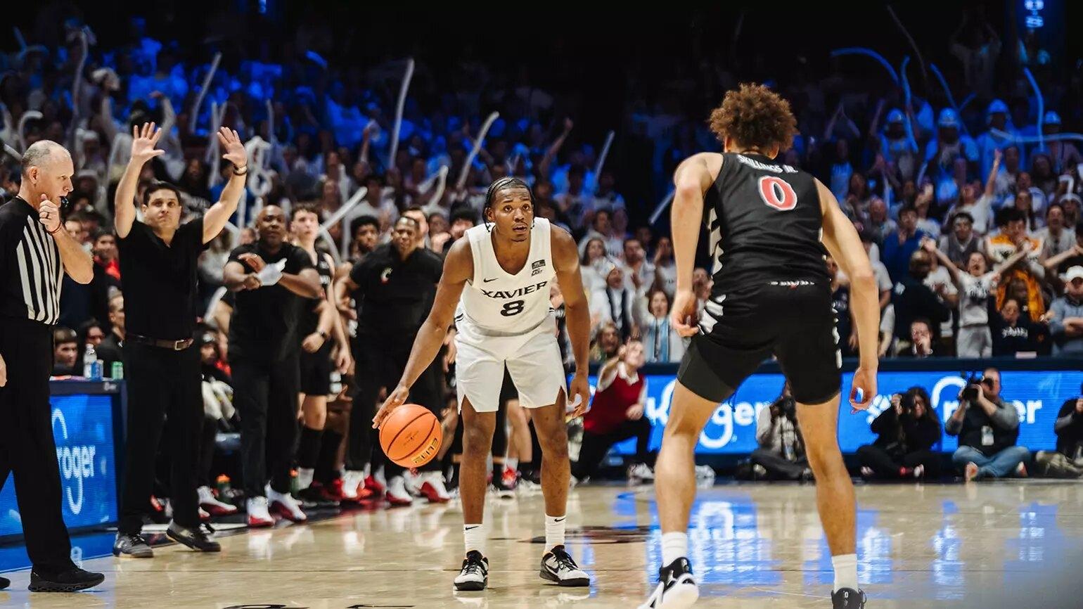 Cincinnati's Dan Skillings Jr. guarding Xavier's Quincy Olivari
